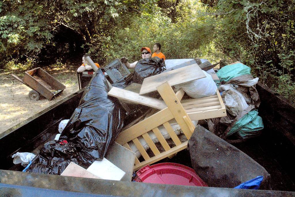 A trailer filled with trash and personal belongings awaits disposal after a sweep of homeless camps in the Morse Creek Valley on Tuesday. (Keith Thorpe/Peninsula Daily News)