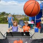 From left, cousins Ivy Bishop, 7, of Bellingham and Maeve Caron, 6, of Portland, Ore., toss basketballs during a hoops game set up at Pebble Beach Park in Port Angeles during Saturdays Jammin in the Park. (Keith Thorpe/Peninsula Daily News)