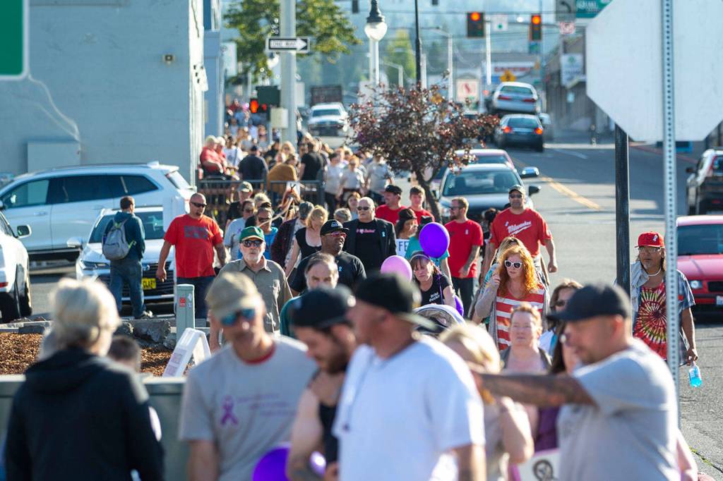 About 150 people walk north on Lincoln Street during the walk. (Jesse Major/Peninsula Daily News)