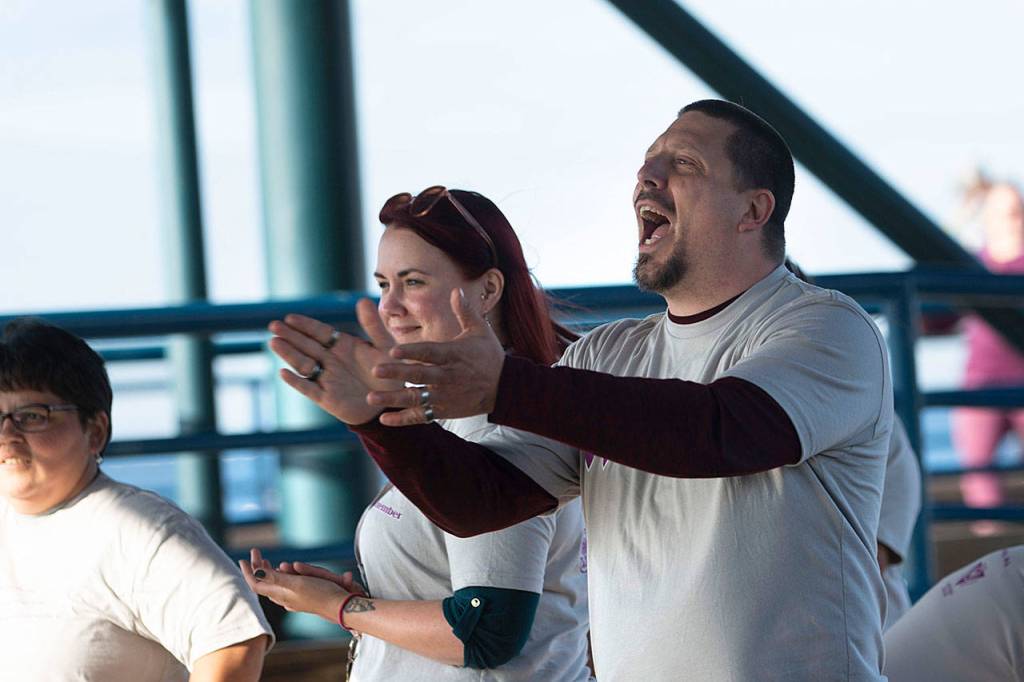 Travis Hedin, clinical supervisor at SS2, cheers as officials from treatment centers in Port Angeles are introduced at the walk. (Jesse Major/Peninsula Daily News)