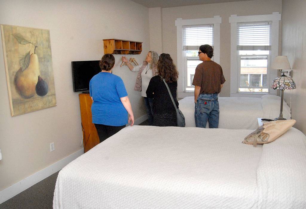 Downtown Hotel visitors, from left, Carmen McElroy, Linda Capps, Jennifer Chenoweth and Pat McElroy examine the furnishings of a guest room Tuesday. (Keith Thorpe/Peninsula Daily News)