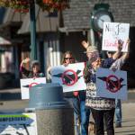 Protesters who oppose FA-18 Growler jets from Naval Air Station Whidbey Island stand outside the Rainforest Arts Center in Forks before U.S. Rep. Derek Kilmers town hall Wednesday evening. (Jesse Major/Peninsula Daily News)