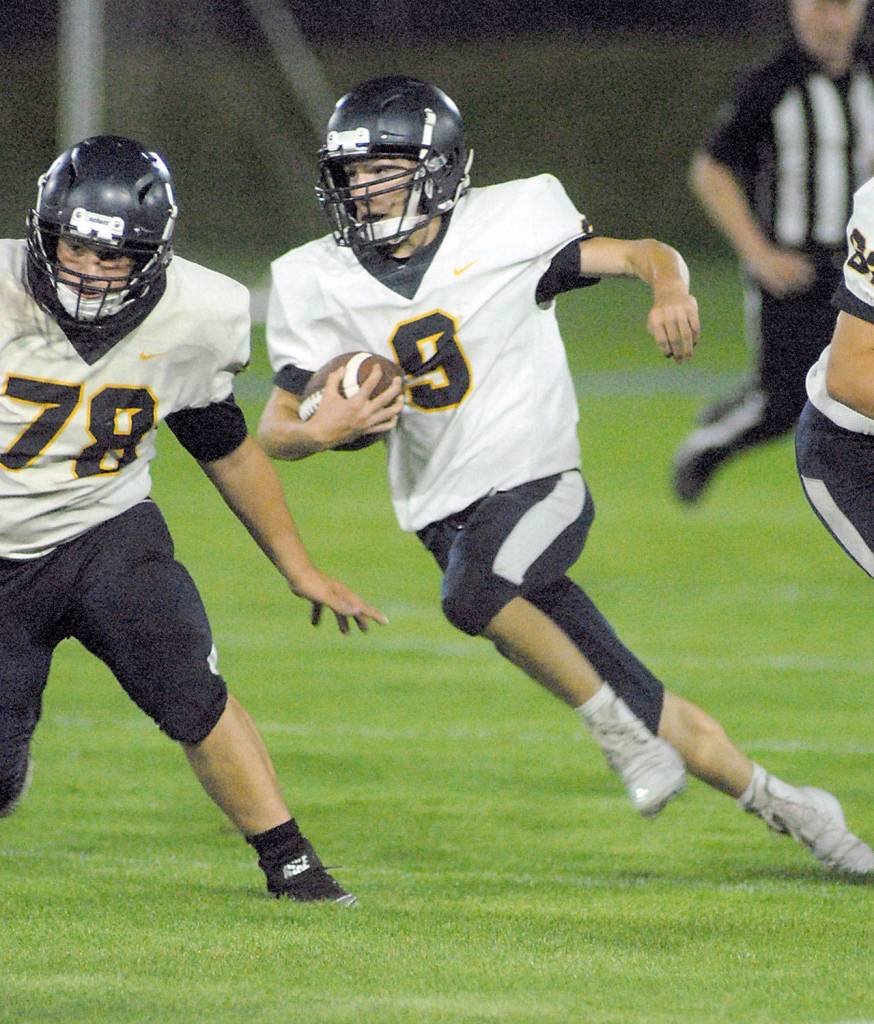 Keith Thorpe/Peninsula Daily News Forks Dalton Kilmer looks for a block from teammate Tyler Ellis during the second quarter against Port Angeles on Friday.
