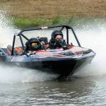 The racing team of Sharon Hauser as navigator, left, and Phil Miller as driver takes the Fat Buddy A400 class boat around the track at Extreme Sports Park in Port Angeles on Saturday. (Keith Thorpe/Peninsula Daily News)