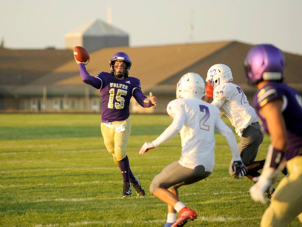 <strong>Michael Dashiell/</strong>Olympic Peninsula News Group                                Sequim quarterback Taig Wiker looks for a two-point conversion in the second quarter of the Wolves match-up with Washington Sept. 6. Wiker connected with Hayden Eaton on the play for the conversion and a 28-0 Sequim lead.