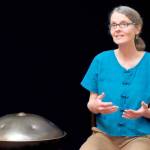 Margo McLoughlin tells a story with her hang, a metal drum, nearby. She will be in Port Angeles on Tuesday.