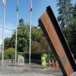 Tera Dummitt of the Port Angeles Parks and Recreation Department pressure-washes the plaza surrounding the I-beam from the World Trade Center at 9/11 Memorial Waterfront Park on Tuesday in Port Angeles in preparation for todays ceremony commemorating the 18th anniversary of the terrorist attacks on New York City and Washington, D.C. (Keith Thorpe/Peninsula Daily News)