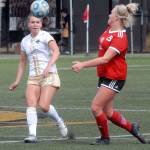 Keith Thorpe/Peninsula Daily News Peninsulas Sammy Howa watches the ball as Skagit Valleys Bonnie Martin closes in on Wednesday at Peninsula College.