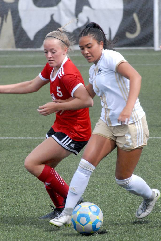 Keith Thorpe/Peninsula Daily News Skagit Valleys MacKenzie Carnell, left, and Peninsulas Kayla Alcott battle for the ball at Wally Sigmar Field on Wednesday.