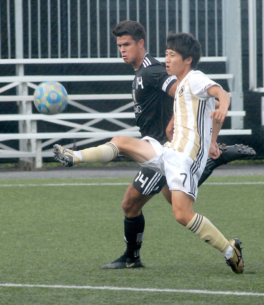 Keith Thorpe/Peninsula Daily News Peninsulas Hide Inoue, front, gets a leg up on Skagit Valleys Christian Gordon in Port Angeles on Wednesday.