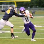 Sequims Michael Young evades a tackle by Forks Carter Windle on Friday at Spartan Stadium. Michael Dashiell/Olympic Peninsula News Group