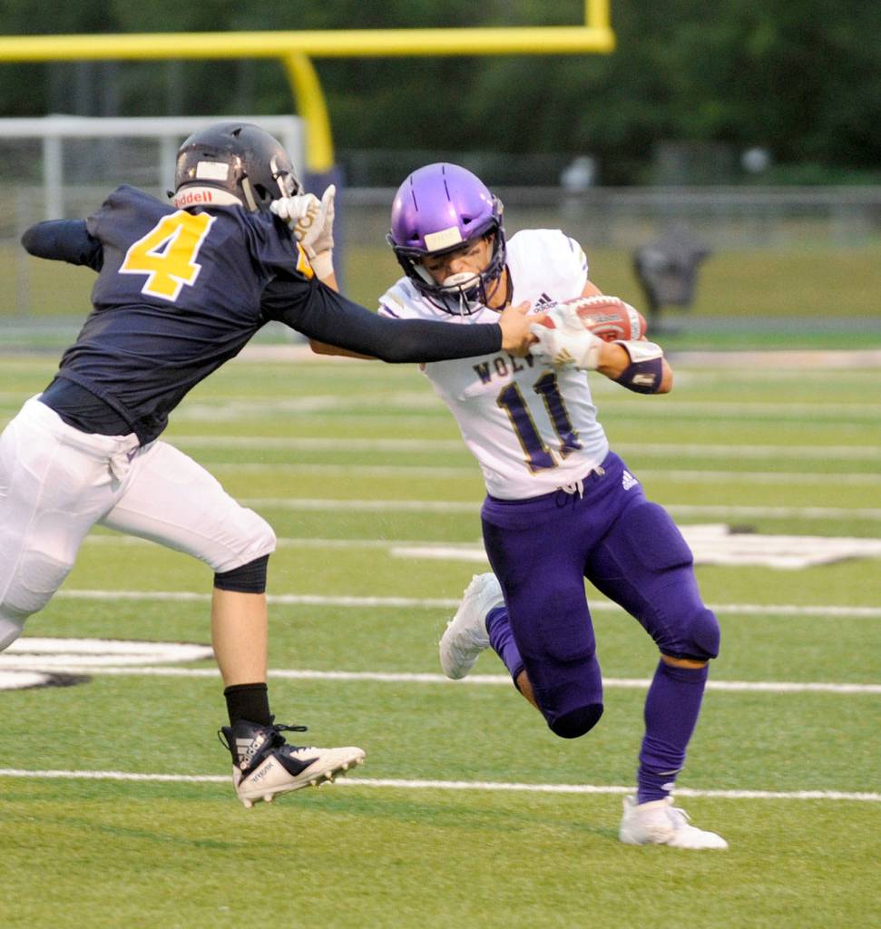 Sequims Michael Young evades a tackle by Forks Carter Windle on Friday at Spartan Stadium. Michael Dashiell/Olympic Peninsula News Group