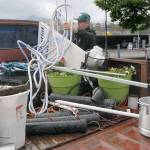 Celestial Espresso co-owner Stan Grall arranges signs and equipment used with the business after being told he had to vacate the coffee stands former location on Railroad Avenue. Plans call for the stand to move into a covered parking garage shown in the background. (Keith Thorpe/Peninsula Daily News)