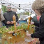 Katie Mountifield, an employee of Port Townsend Brewing, right, pours a sample of her companys beer for Christina and Cody Pettersen of Seattle during the 2018 Arts & Draughts Festival. (Keith Thorpe/Peninsula Daily News)