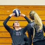 Michael Dashiell/Olympic Peninsula News Group With teammate Kendall Hastings looking on, Sequim junior Kalli Wiker (21) looks to set a teammate against Bremerton during the Wolves three-game sweep of the Knights.