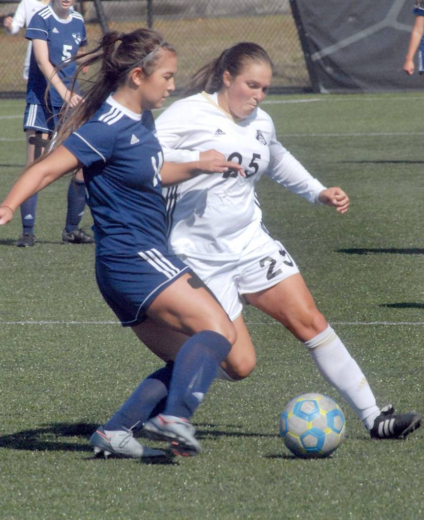 Keith Thorpe/Peninsula Daily News Whatcoms Jayden Nguyen, left, and Peninsulas Sam Oliveira fight for the ball on Wednesday at Wally Sigmar Field in Port Angeles.