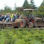 A tractor takes people on a hayride through Lazy J Tree Farm east of Port Angeles in 2018 as part of the annual Clallam County Farm Tour. (Keith Thorpe/Peninsula Daily News)