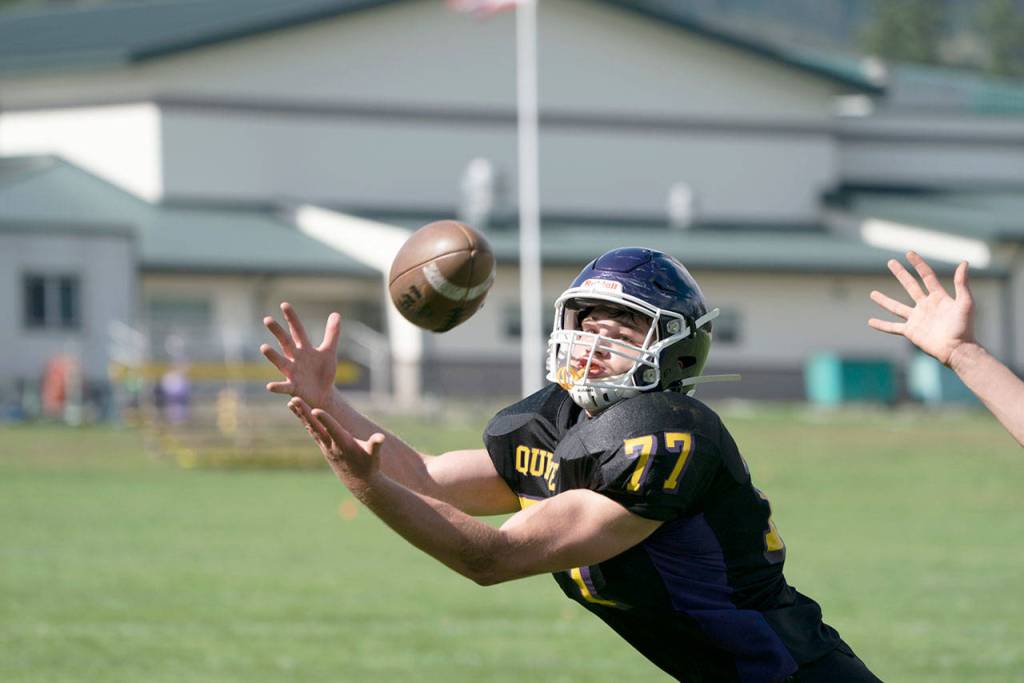 Steve Mullensky/for Peninsula Daily News Quilcenes Zach Budnek dives for a pass during a game against Neah Bay on Saturday in Quilcene.