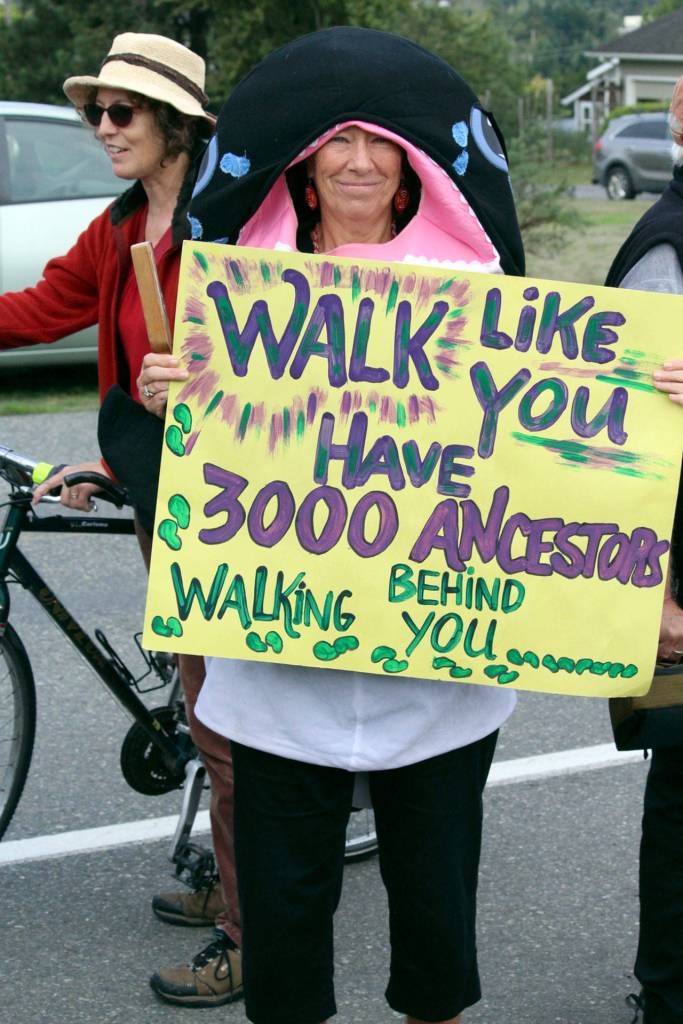 Terry Dubeau of the North Olympic Orca Pod stands with her sign while at the Global Climate Change rally that Port Townsend High School students led Friday morning. (Zach Jablonski/Peninsula Daily News)