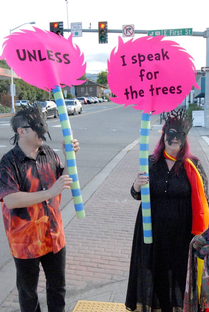 Dressed as flaming trees, Jeff and Roberta Brock of Port Angeles take their cue from the Dr. Seuss book The Lorax as the couple calls for action on climate change during Fridays Climate Strike march through downtown Port Angeles. (Keith Thorpe/Peninsula Daily News)