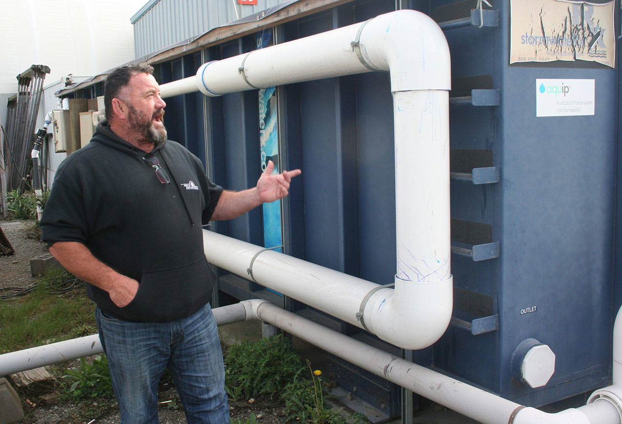 Terry Khile, the hoist and yard manager for the Port of Port Townsend, said stormwater collected in one of five separate areas at the boatyard travels through a filtration box that has several levels of mixed media, including sand and biochar, before its released into Puget Sound. (Brian McLean/Peninsula Daily News)