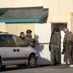 Olympic Peninsula Narcotics Team members enter the Tempest permanent-supportive housing appartments to serve a search warrant Wednesday. (Jesse Major/Peninsula Daily News)