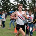 Steve Mullensky/for Peninsula Daily News Port Townsends Nathan Cantrell crosses the finish line in 10 minutes, 27 seconds to take the boys cross country race at Port Townsend Golf Course on Wednesday.