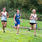 Steve Mullensky/for Peninsula Daily News Port Townsends Anika Avelino, left, North Masons Kelzie Thygesen and Rachel Matthes, go stride for stride during a 2-mile cross country race at Port Townsend Golf Course on Wednesday. Avelino won the race with a time of 12:39.