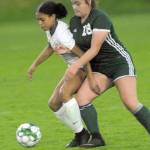 Keith Thorpe/Peninsula Daily News North Kitsaps Kamora McMillian, left, and Port Angeles Kiana Watson-Charles battle for ball control on Thursday night at Port Angeles Civic Field.
