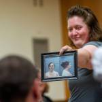 Sandra Schroeder, following drug court tradition, shares her mugshot with other drug court participants as she graduates. (Jesse Major/Peninsula Daily News)