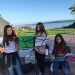 Port Townsend High School orchestra students Leona Lee, left, Kerith Pray and Kaylen Pray perform near Pope Marine Park on Water Street during the Port Townsend Film Festival to help raise money for their trip to Los Angeles in the spring. (Daniel Ferland)
