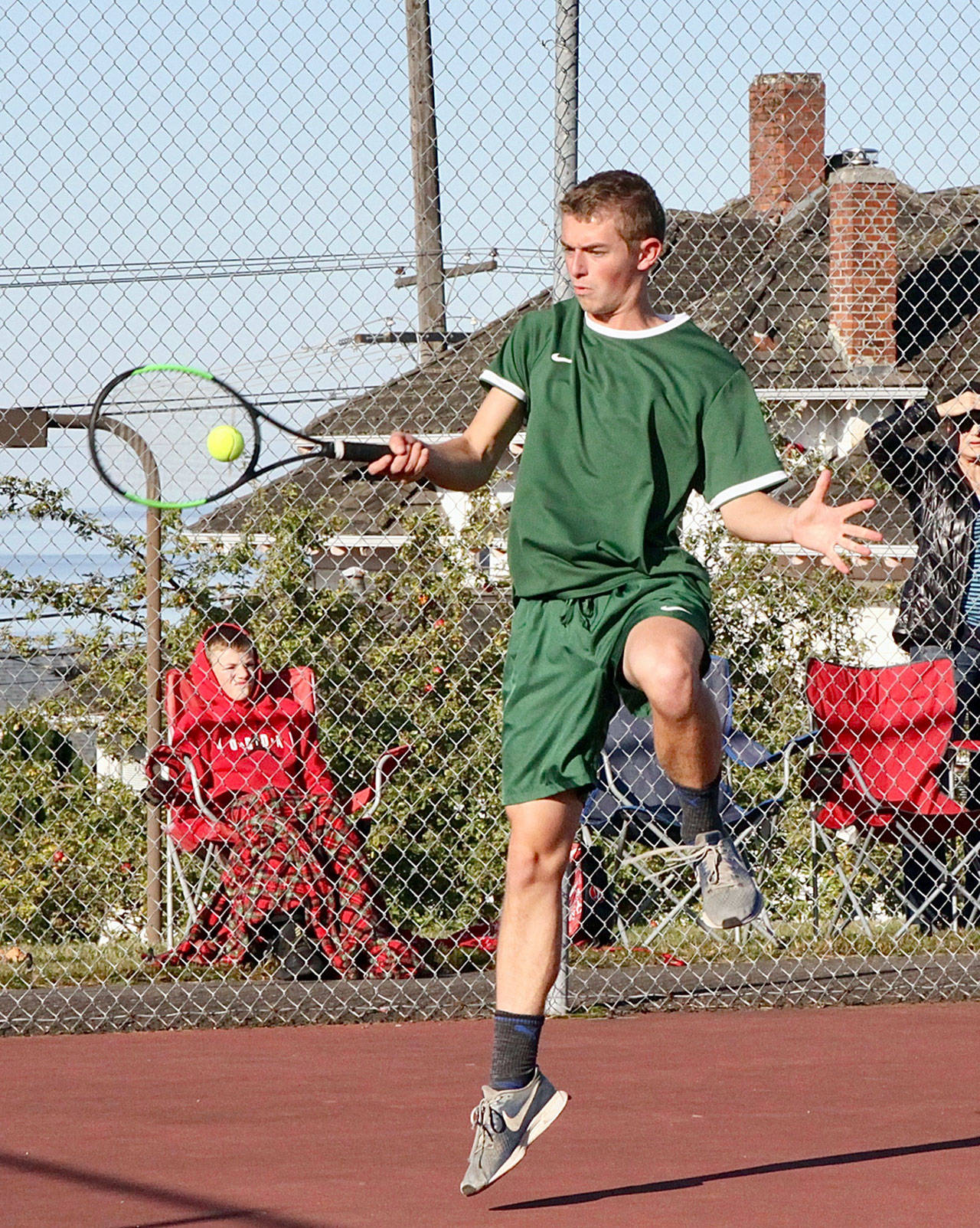 Port Angeles No. 1 singles tennis player Caleb Flodstrom returns a volley in his match Monday against Chimacums Roman Powell. Flodstrom won a hard-fought three-set match over Powell. (Dave Logan/for Peninsula Daily News)