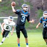 Steve Mullensky/for Peninsula Daily News Cowboy quarterback Henry Brebberman throws a completion during a game in Port Townsend on Friday.