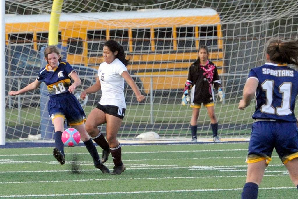 Spartan Brynley Ponton (18) challenges South Bends Zaira Medina (5) for ball control. Looking on for Forks are Aspen Rondeau (11) and goalie Leslie Beltran. (Lonnie Archibald/for Peninsula Daily News)