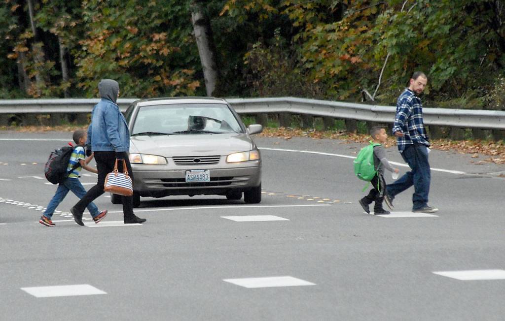 Parents and children cross Race Street at Lauridsen Boulevard in Port Angeles after school Wednesday afternoon. (Keith Thorpe/Peninsula Daily News)