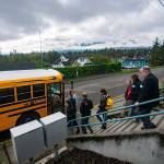 Community members load into a school bus before they tour Stevens Middle School in Port Angeles. (Jesse Major/Peninsula Daily News)