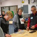 Karen Winther and Robert Skolnile visit an engineering class during a tour of Stevens Middle School. (Jesse Major/Peninsula Daily News)