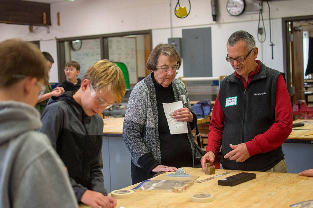 Karen Winther and Robert Skolnile visit an engineering class during a tour of Stevens Middle School. (Jesse Major/Peninsula Daily News)