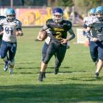 Steve Mullensky/for Peninsula Daily News Quilcenes Bishop Budnek picks up a first down during a game against Rainier Christian. Budnek is one of three 1,000-yard rushers on the North Olympic Peninsula.