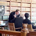 Defense attorney Jake Range, left, speaks with defendant Denver Shoop, 73, during Tuesdays proceedings in Jefferson County Superior Court. Shoop is facing a jury trial for the second time on animal cruelty charges based on the condition of eight bison that were seized from his Chimacum property in April 2018. (Brian McLean/Peninsula Daily News)