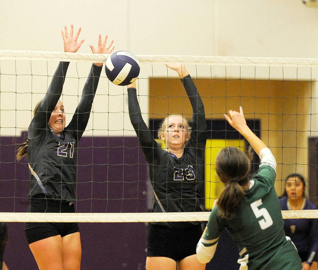 Michael Dashiell/Olympic Peninsula News Group Sequims Kalli Wiker, left, and McKenna Hastings look to block a hit from Port Angeles Emi Halberg (5).