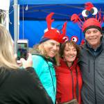 Denise Stephens of Surry, B.C., left, takes a photograph of crab hats worn by her friends, from left, of Sharon and Dave Cherry of Surry, and Cathie Hagenson of Comox, B.C., on Saturday at the Dungeness Crab and Seafood Festival in Port Angeles. (Keith Thorpe/Peninsula Daily News)