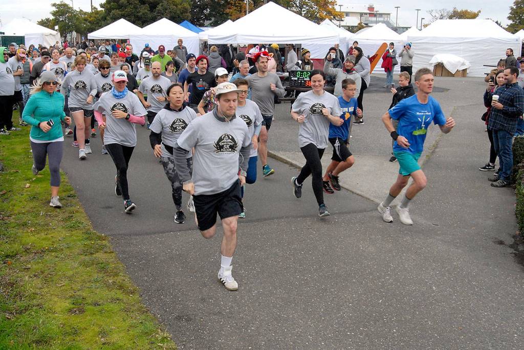 Runners and walkers take off from the start of Saturdays CrabFest 5K Run along the Waterfront Trail from Port Angeles City Pier. The race was a benefit for the Peninsula College womens basketball program. (Keith Thorpe/Peninsula Daily News)