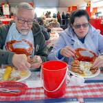 John and Darcy McTernan of Kirkland enjoy a crab dinner in the Dungeness Crab and Seafood Festival main tent in the parking lot of the Red Lion Hotel. (Keith Thorpe/Peninsula Daily News)