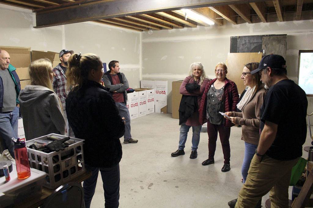 The Haunt Town cast and crew discuss the different rooms within the haunted house during their Thursday night rehearsal, before opening night Friday in the basement of the Elks Lodge. (Zach Jablonski/Peninsula Daily News)