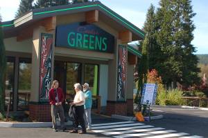 Cedar Greens general operations manager Mike Smith, left, speaks with two attendees of the grand opening for the Jamestown SKlallam Tribes new cannabis dispensary store. (Conor Dowley/Olympic Peninsula News Group)