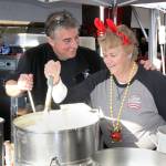 Dave Logan/For Peninsula Daily News Diana Losch, right, volunteers at CrabFest one last time, stirring a pot with friend Toga Hertzog.