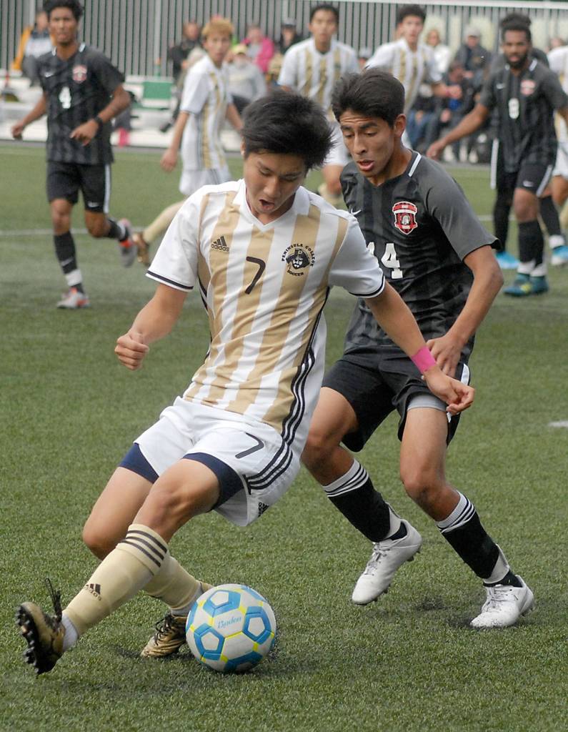 Keith Thorpe/Peninsula Daily News Peninsulas Hide Inoue tries to keep the ball away from Everetts Geraldo Lopez in the first half on Saturday in Port Angeles.