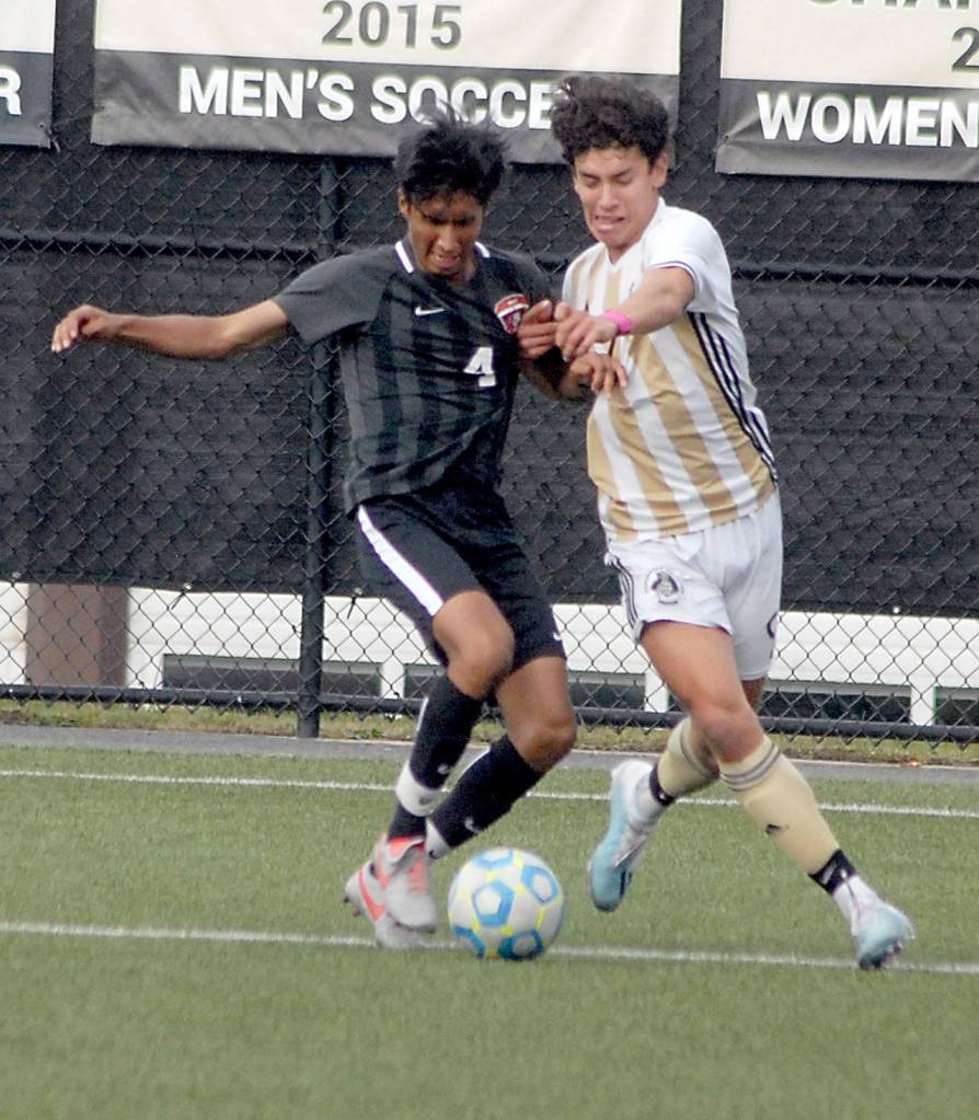 Keith Thorpe/Peninsula Daily News Efren Martinez of Everett, left, and Nicolas Hernandez of Peninsula fight for ball control on Saturday at Wally Sigmar Field.