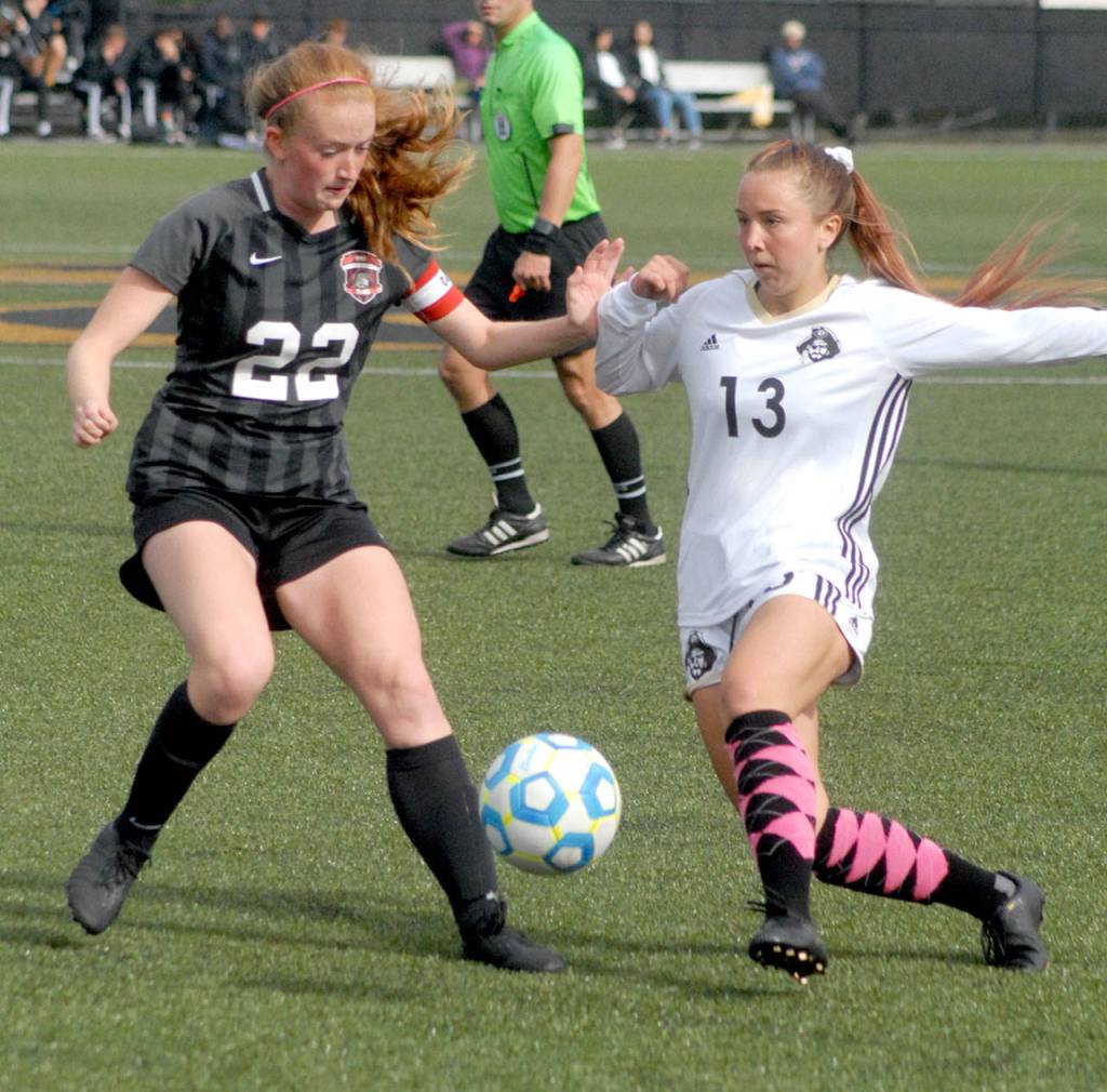 Keith Thorpe/Peninsula Daily News Peninsulas Grace Hipke, right, attempts to get past the defense of Everetts Caitlynn Daniel on Saturday in Port Angeles.